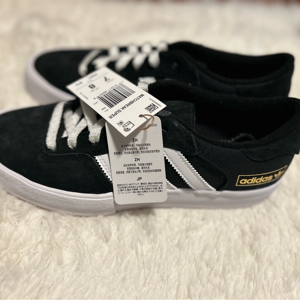 Adidas sneakers. Men’s size 7, women’s size 8.  Still in original box with tags.